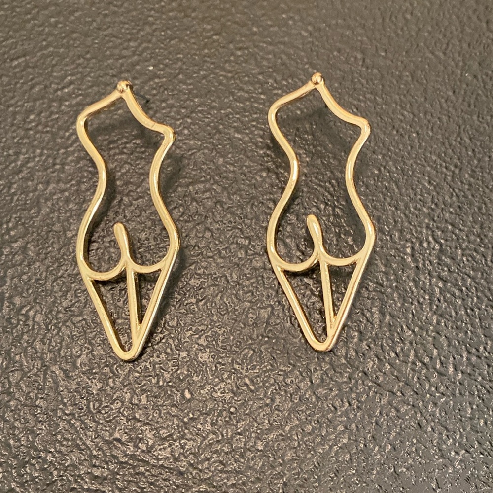 Gold, naked girl, earrings.  These are costume.